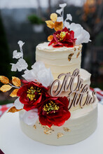 Wedding Cake Decorated With Red Flowers
