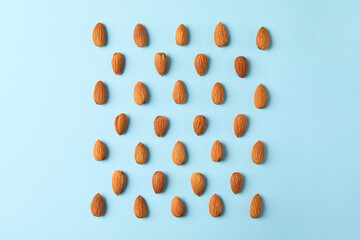 Wall Mural - Flat lay with almond on blue background. Vitamin food