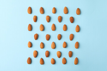 Poster - Flat lay with almond on blue background. Vitamin food