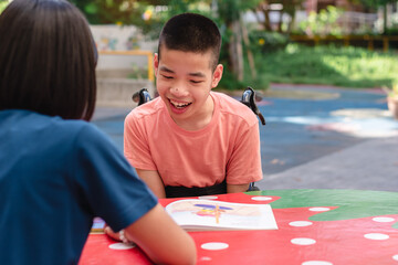 Disabled child on wheelchair happy time to home school and reading a book, Study and Work at home for safety from covid 19, Life in the education age of special need kid, Happy disability boy concept.