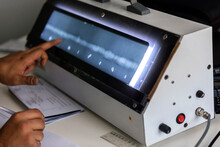 The Inspector Evaluation Radiography Of The Weld Metal With X-Ray Film Viewer Box. He Write Some Reports About Weld Metals. 