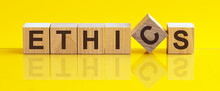 Ethics Word Background On Wood Blocks, Yellow Background