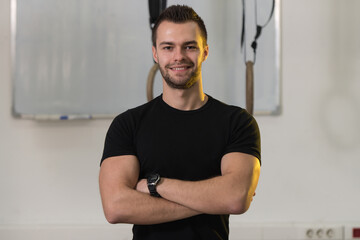 Muscular Man In Sports Outfit In Fitness Center