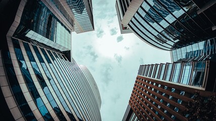 Wall Mural - Low angle shot of modern buildings under the grey sky