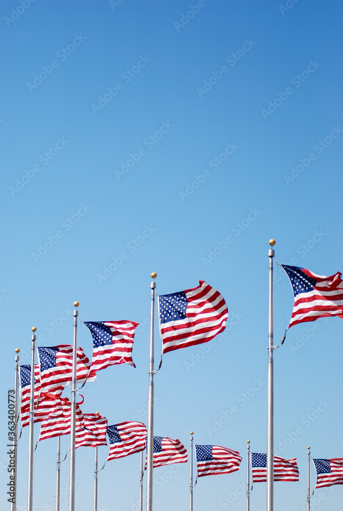 Low Angle View Of National Flags Against Clear Blue Sky - obrazy, fototapety, plakaty 