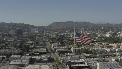 Wall Mural - Drone, panoramic footage of an american flag with Hollywood as a background