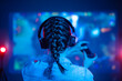 © Anton - Gemer player plays a game on a large screen with the help of a joystick, creative light, streamer, streaming games and a blogger