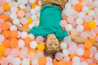Child playing in ball pit. Colorful toys for kids. Kindergarten or preschool play room. Toddler kid at day care indoor playground. Balls pool for children. Birthday party for active preschooler
