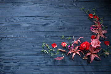  beautiful summer flowers on dark blue wooden background