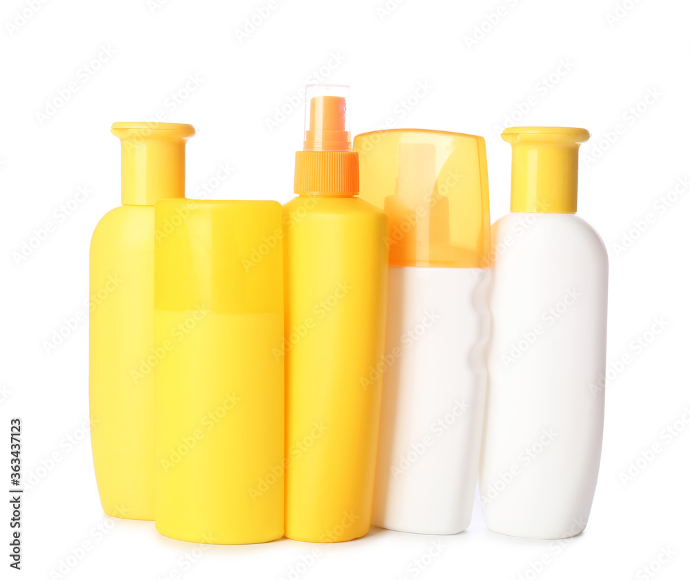 Bottles of sunscreen on white background