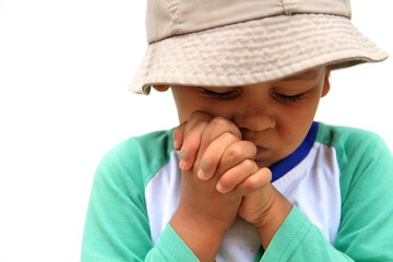 Canvas Print - boy praying with hands together on white background stock photo