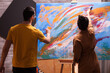 © DC Studio - Talented young couple painting on canvas in art workshop. Modern artwork paint on canvas, creative, contemporary and successful fine art artist drawing masterpiece