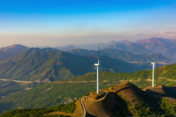 Wind turbines are up in the mountains.