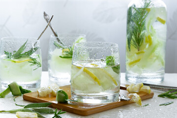 Refreshing iced drink with lemon and fresh rosemary, detox summertime