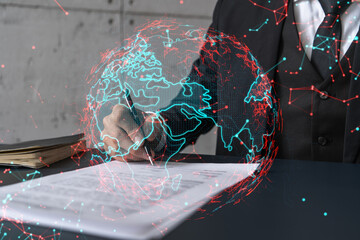 businessman in suit signs contract. double exposure with world map hologram. man signing agreement i