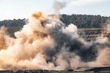 Canvas Print - Explosive works on open pit coal mine industry. Dust and puffs of smoke in sky, blasted soil