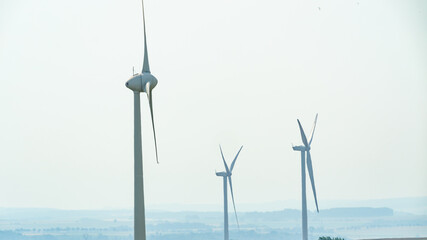 Close up of wind turbines off into the distant landscape