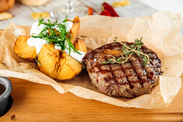 Wall Mural - Ribeye beef steak with baked potatoes  sour cream