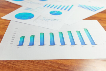 Charts and graphs are placed on the desks, data, and statistical performance of the company.