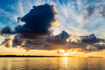 Wall Mural - Sunrise dramatic sky over sea, tropical islands, unique stormy clouds and golden sunlight, travel destination, Indonesia Banyak Islands Sumatra