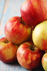 Wall Mural - Several ripe red apples on the wooden table