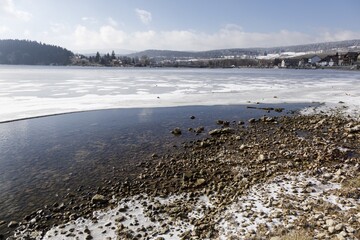 Sticker - High angle shot of a frozen beach with lots of small rocks