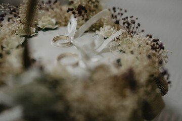 Canvas Print - Selective focus shot of the original wedding decoration with two golden rings