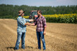 © Budimir Jevtic - Farmers shaking hands in field during harvest