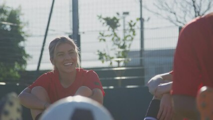 Wall Mural - Female soccer team chatting during break in warm up training before match - shot in slow motion