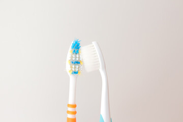  Red and blue toothbrushes on a gray background. Old and new toothbrush. Oral hygiene concept. copy space for text