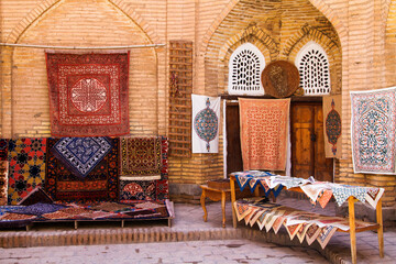 The wide range of the hand made carpets in traditional style in the small bazaar, Khiva, Uzbekistan, Central Asia