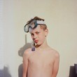 © L√©a Jones/Stocksy - boy with his goggles and tuba