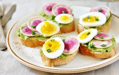 Wall Mural - watermelon radish sandwich with avocado and egg. healthy balanced breakfast. bright toast