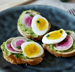 Canvas Print - watermelon radish sandwich with avocado and egg. healthy balanced breakfast. bright toast