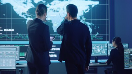 Poster - Project Manager and Computer Science Engineer Talking while Using A Digital Tablet Computer. Telecommunications Company System Control and Monitoring Office Room with Working Specialists.