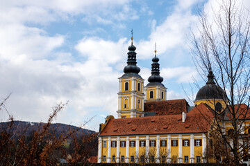 beautiful yellow church in front of a cloudy blue sxy