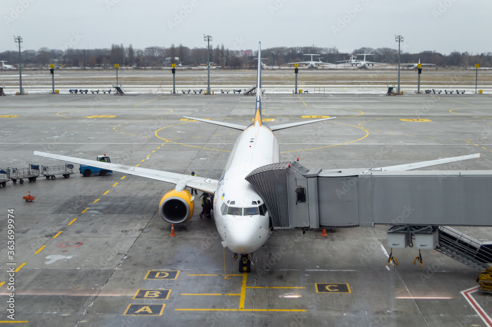 Air plane with jet bridge connected, ready to receive passengers at the ...