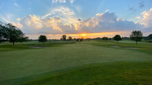 Sunrise On Golf Course Big Clouds Sand Traps Greens