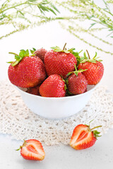 Fresh strawberry in a bowl and two halves