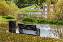 Empty Metal Bench In Flooded Park