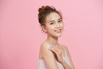 Wall Mural - Beautiful smiling woman with clean skin, natural make-up, and white teeth on pink background.