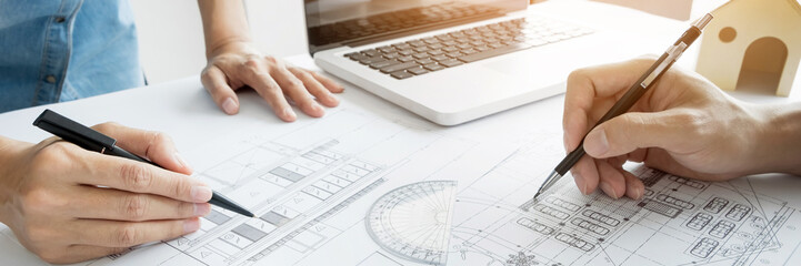 Wall Mural - Engineer of architect starting draw a house blueprint on the desk in the office at construction working site