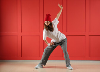 Wall Mural - Beautiful female hip-hop dancer against color wall