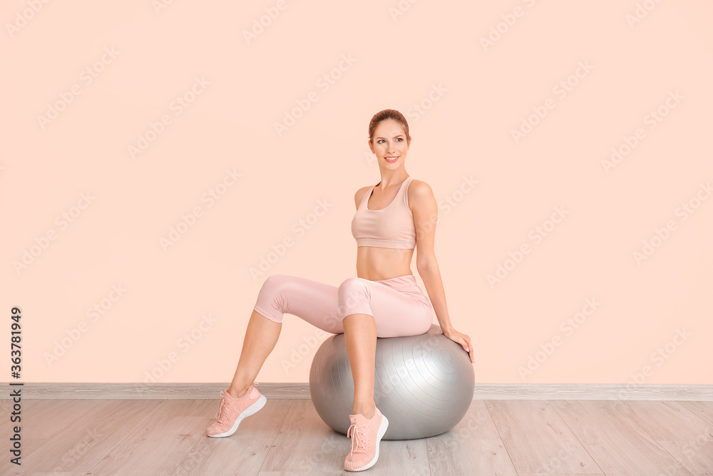 Sporty young woman training at home