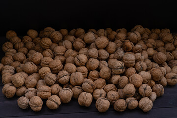 Ripe walnuts on a wooden background