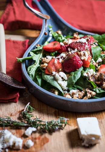 Close-up of balsamic vinaigrette being drizzled on fresh Strawberry and Feta Salad with walnuts and Arugula Poster Mural XXL