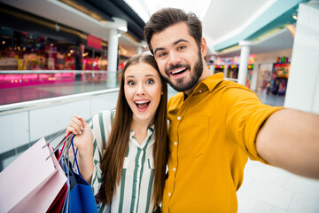 Sticker - Portrait ogf two people boyfriend girlfriend guy blogger make selfie video call his sweetheart buy purchase hold packages enjoy rejoice trip in shopping mall center