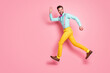Full length body size profile side view of his he nice well-dressed attractive classy cheerful cheery glad brunet guy gentleman jumping running waving hi isolated on pink pastel color background