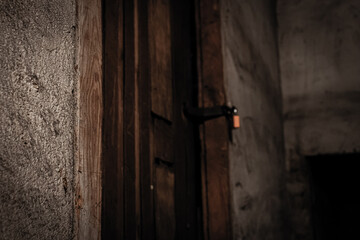 A padlock in the door in the old dark basement