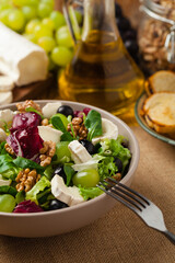 Wall Mural - Italian spring salad with goat cheese, grapes and walnuts. Served with croutons.